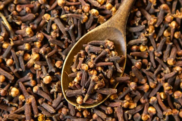 dried cloves with a wooden spoon